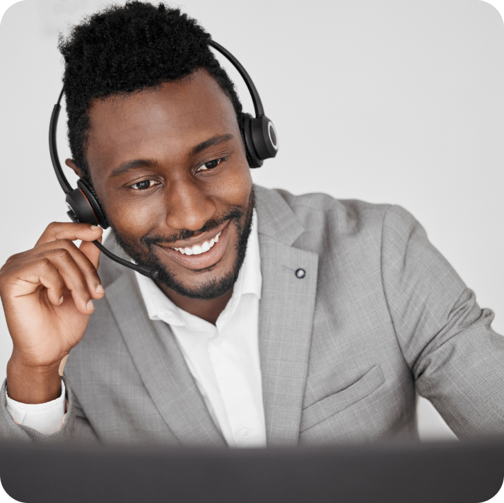 The customer support agent wearing a headset is on a call with a customer.