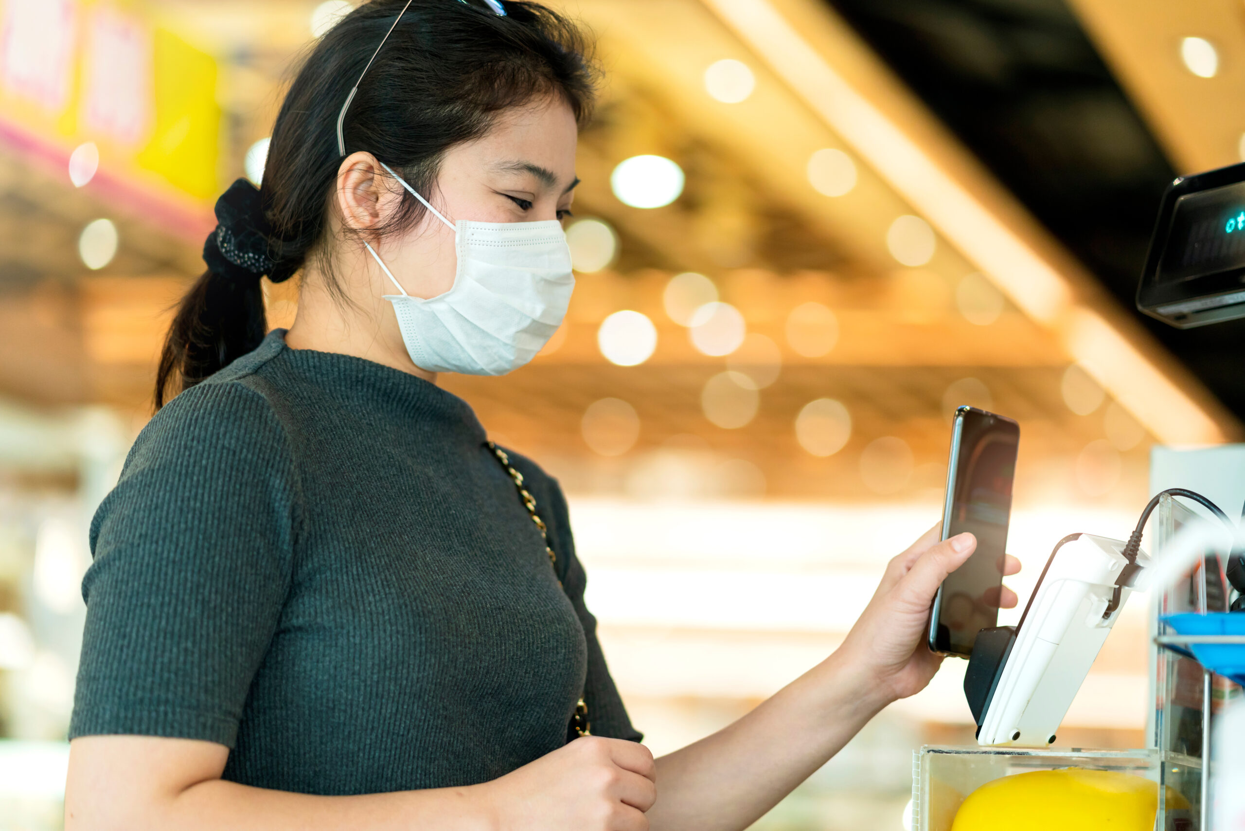 new normal after covid epidemic asian female payment progress buy scaning app by smarthine cashless and touchless new lifestyle shopping in department store cashier counter
