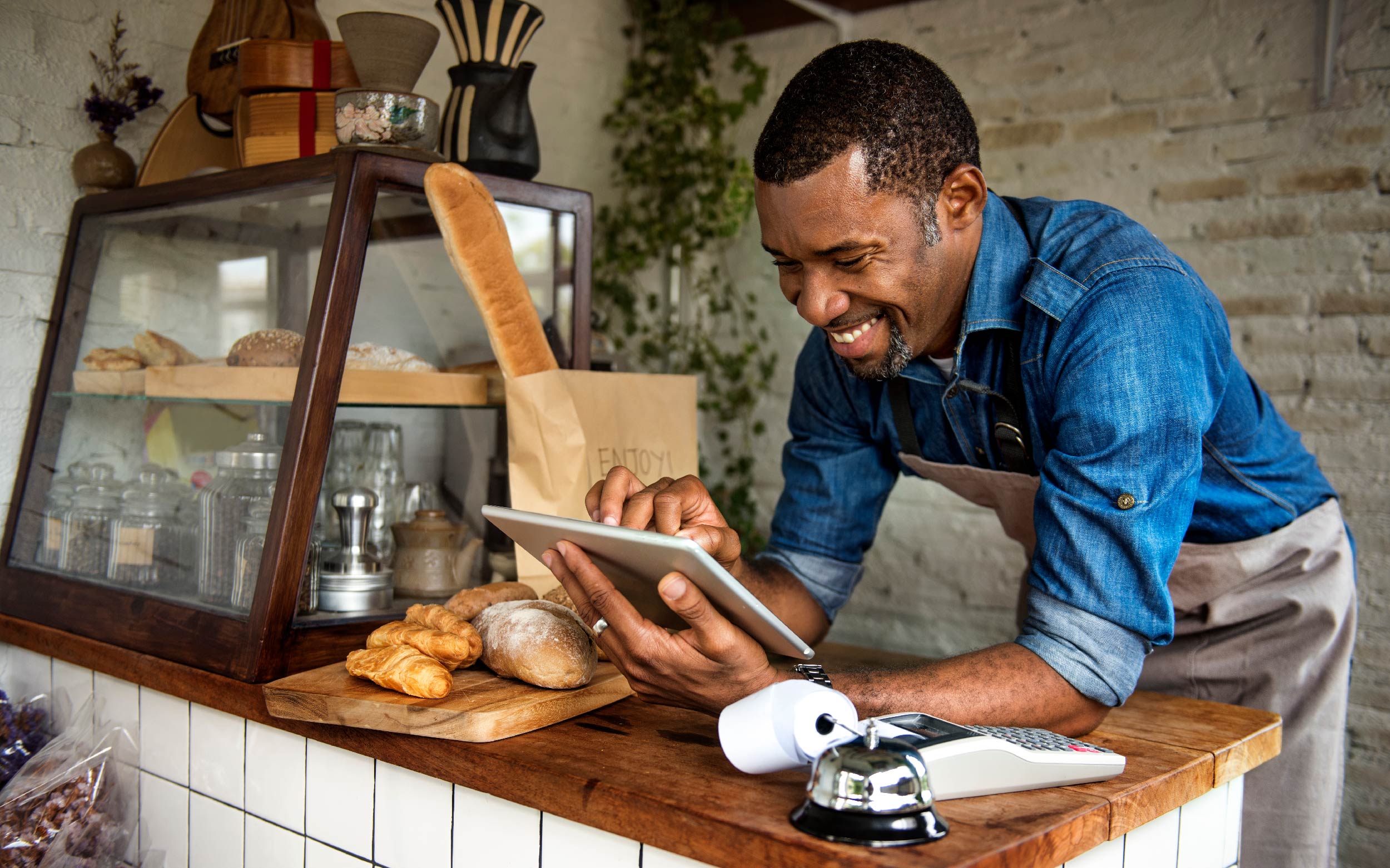 Waiter tracking his business data on a tablet