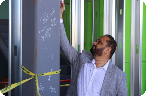 CEO Sohail Modi signing the beam of the new Modisoft Headquarters