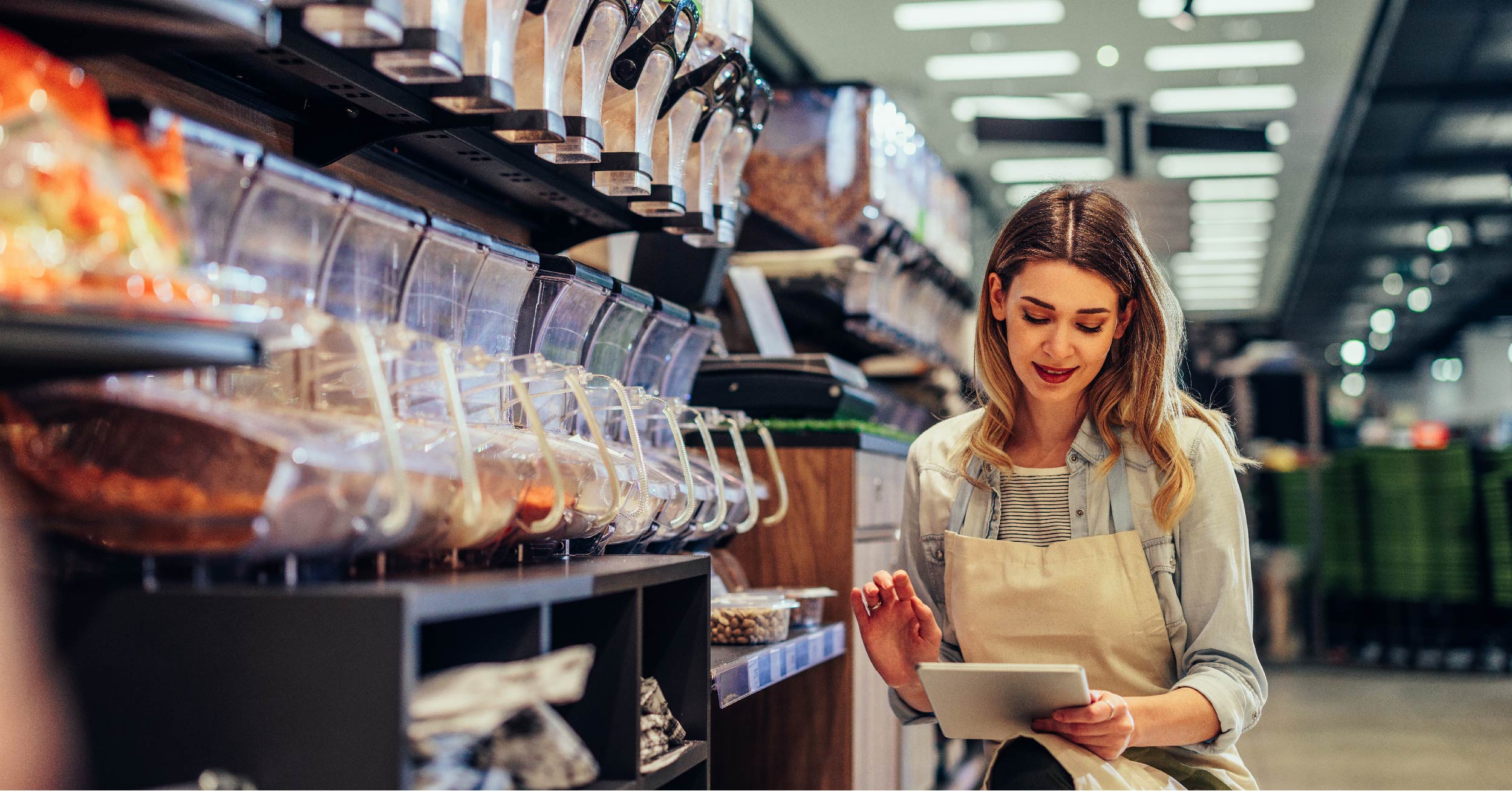 Convenience store worker manually taking inventory